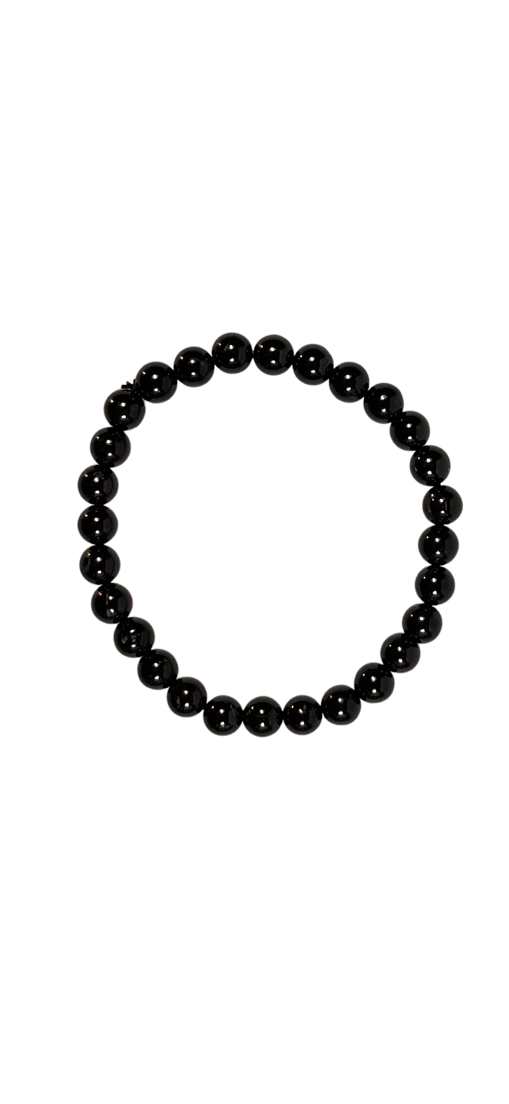 Ein elastisches Armband aus poliertem schwarzem Turmalin. Die runden Edelsteinperlen glänzen tiefschwarz und sind gleichmäßig aneinandergereiht. Das Armband liegt freigestellt auf hellem Hintergrund und vermittelt eine schlichte, kraftvolle Eleganz – ideal für Schutz, Klarheit und einen minimalistischen Look.